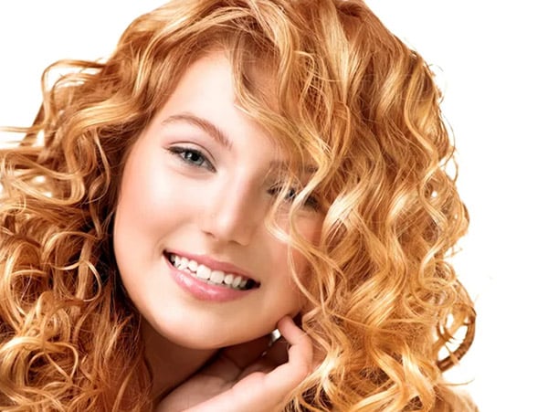 Woman with curly, strawberry blonde hair